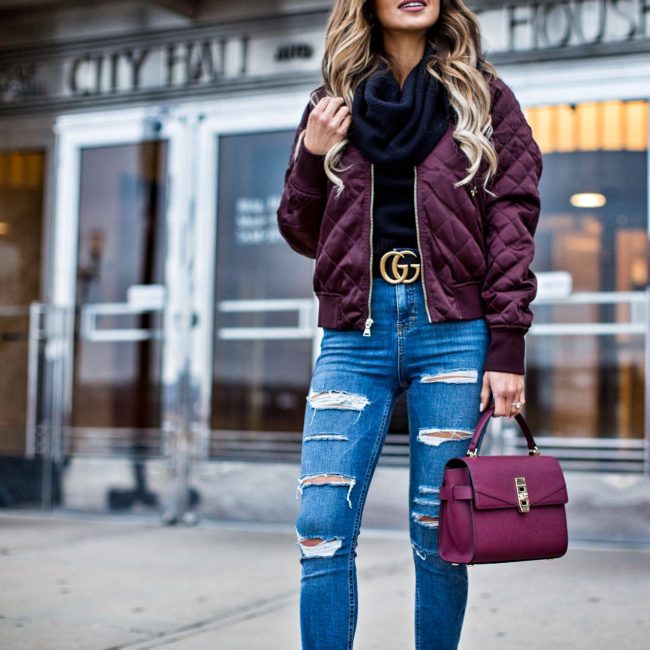 fashion blogger mia mia mine carrying a burgundy bag from henri bendel