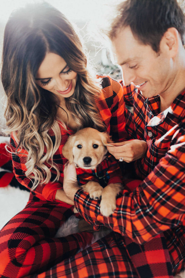 fashion blogger mia mia mine wearing plaid pajamas with husband phil thompson and golden retriever puppy luna