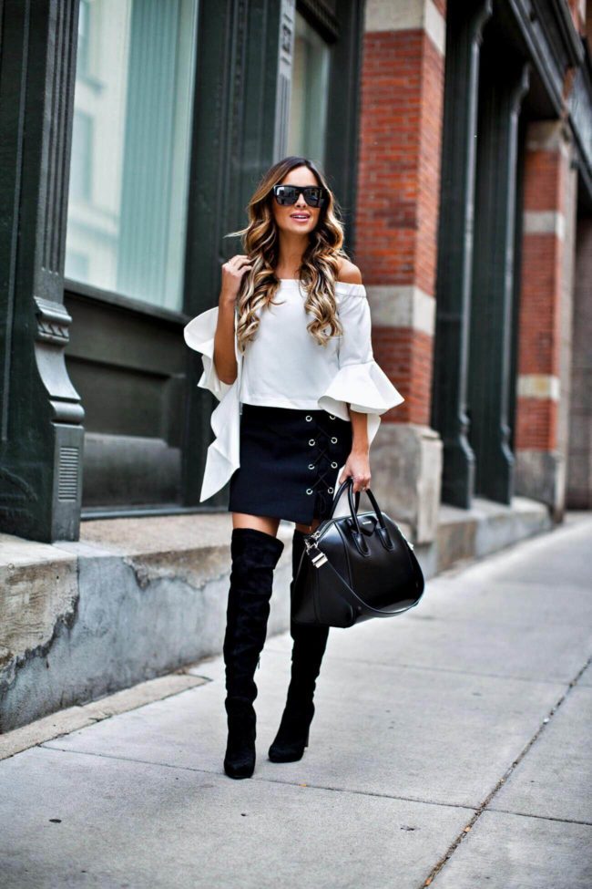mn fashion blogger mia mia mine wearing a white off-the-shoulder top and a lace-up skirt from chicwish