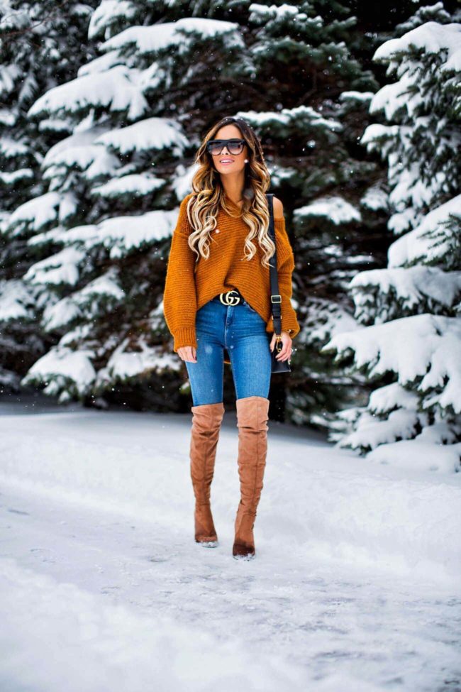 fashion blogger mia mia mine wearing over-the-knee boots from nordstrom and an orange off-the-shoulder sweater