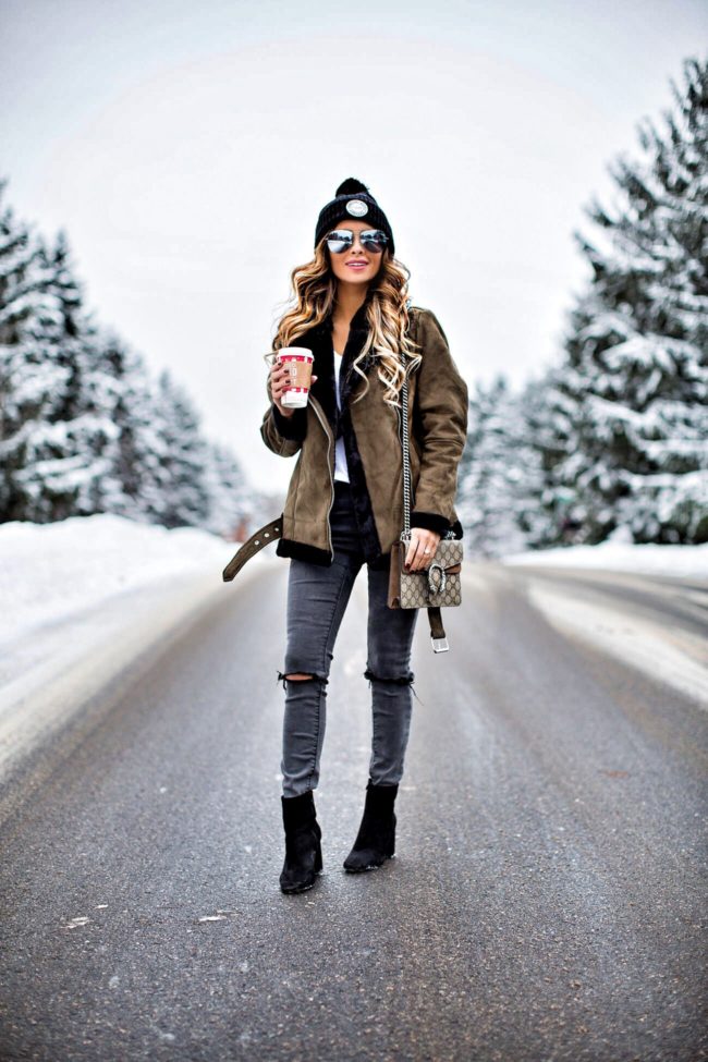 fashion blogger mia mia mine wearing a green shearling jacket and black booties from nordstrom