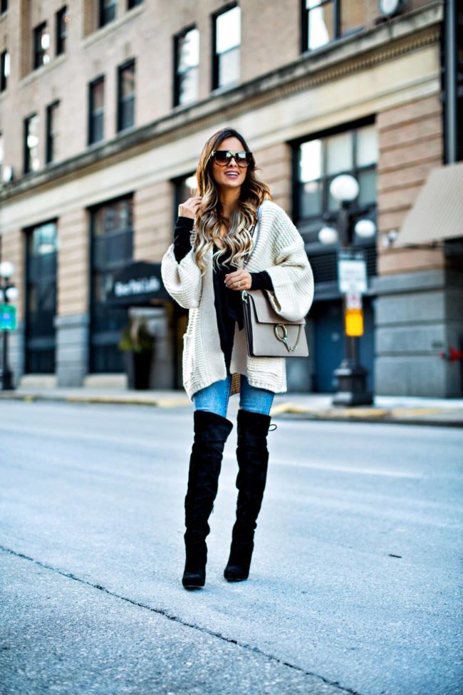 fashion blogger mia mia mine wearing a cardigan from revolve and over-the-knee boots from nordstrom