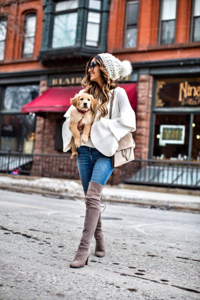 fashion blogger mia mia mine wearing a white sweater from nordstrom and a golden retriever puppy