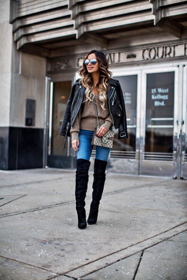 mn fashion blogger mia mia mine wearing a leather jacket and a gucci bag