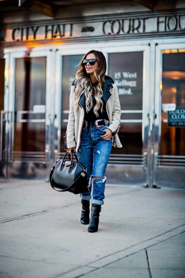 fashion blogger mia mia mine wearing a shearling jacket and ripped jeans from revolve