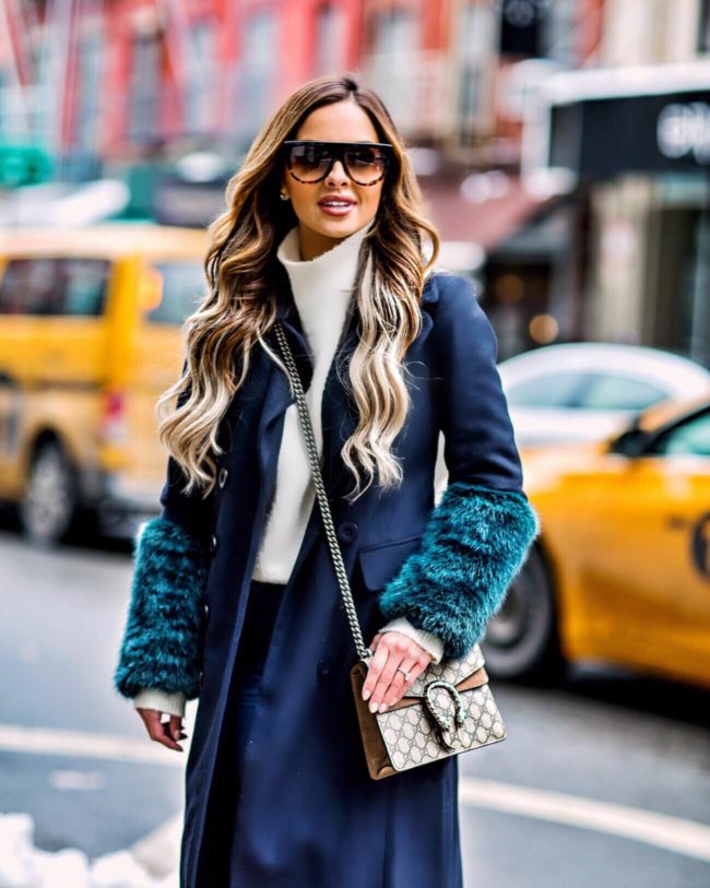 mia mia mine wearing a faux fur navy coat at new york fashion week