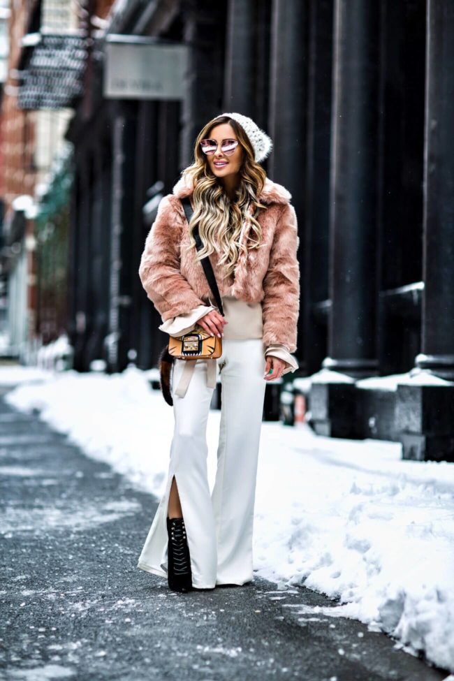 nyfw fashion blogger mia mia mine wearing a faux fur coat and revolve pants