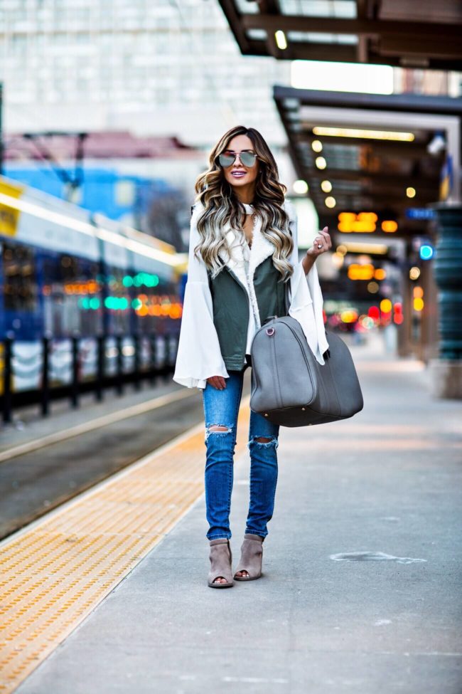fashion blogger mia mia mine carrying a sole society weekender bag and booties