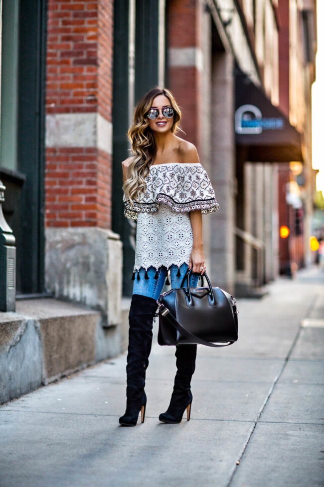 fashion blogger mia mia mine wearing a tassel top from revolve and over-the-knee boots from nordstrom