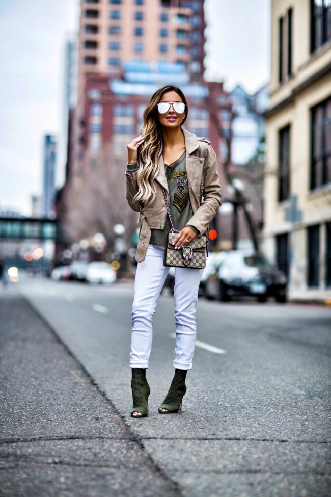 fashion blogger mia mia mine wearing a suede jacket from revolve and a white jeans
