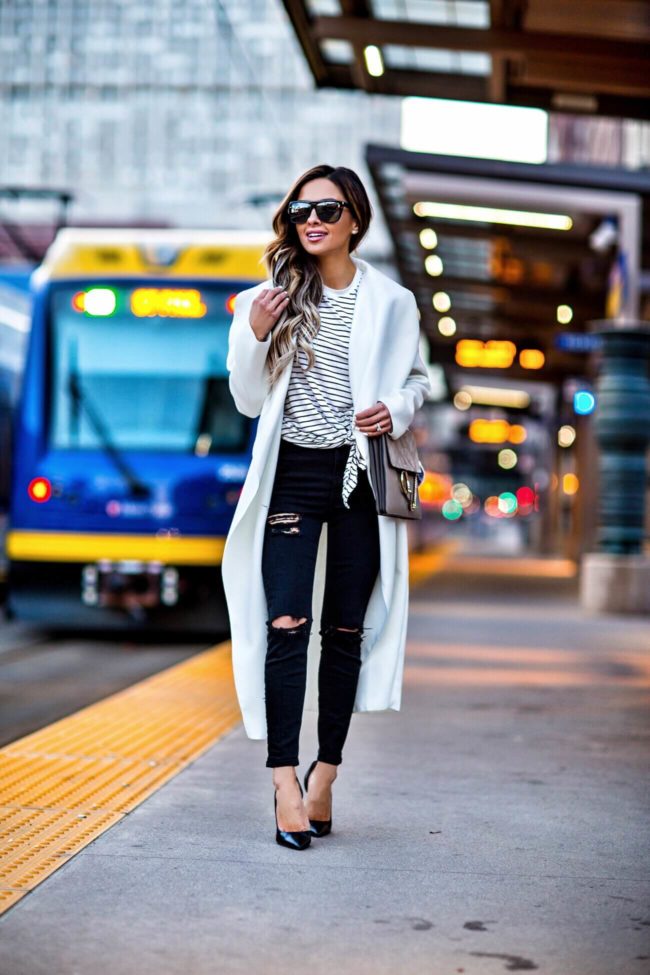 fashion blogger mia mia mine wearing a striped top from shopbop and a white missguided duster coat