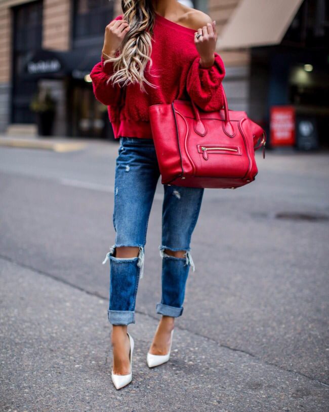 fashion blogger mia mia mine wearing a red top from nordstrom and ripped jeans from revolve