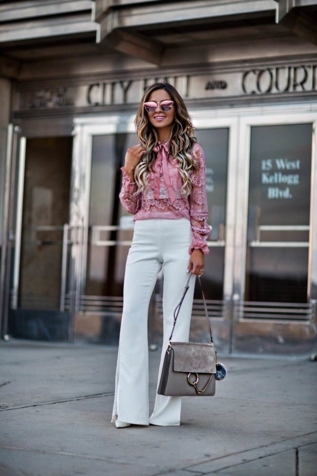 mn fashion blogger mia mia mine wearing a pink lace top from shopbop and white pants from revolve