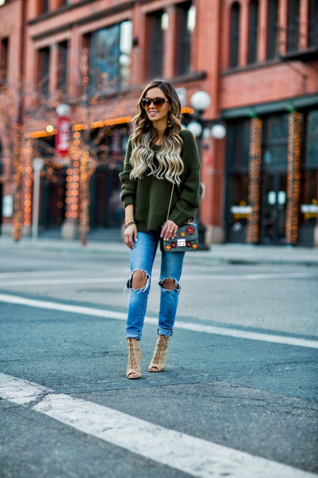 fashion blogger mia mia mine wearing a henri bendel bag and sunglasses