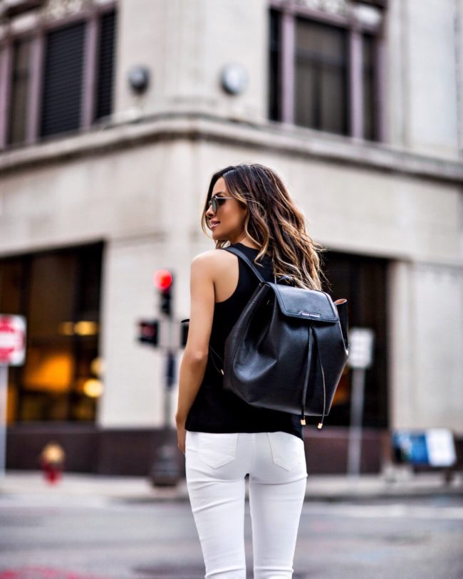 fashion blogger mia mia mine wearing a black armani exchange backpack 