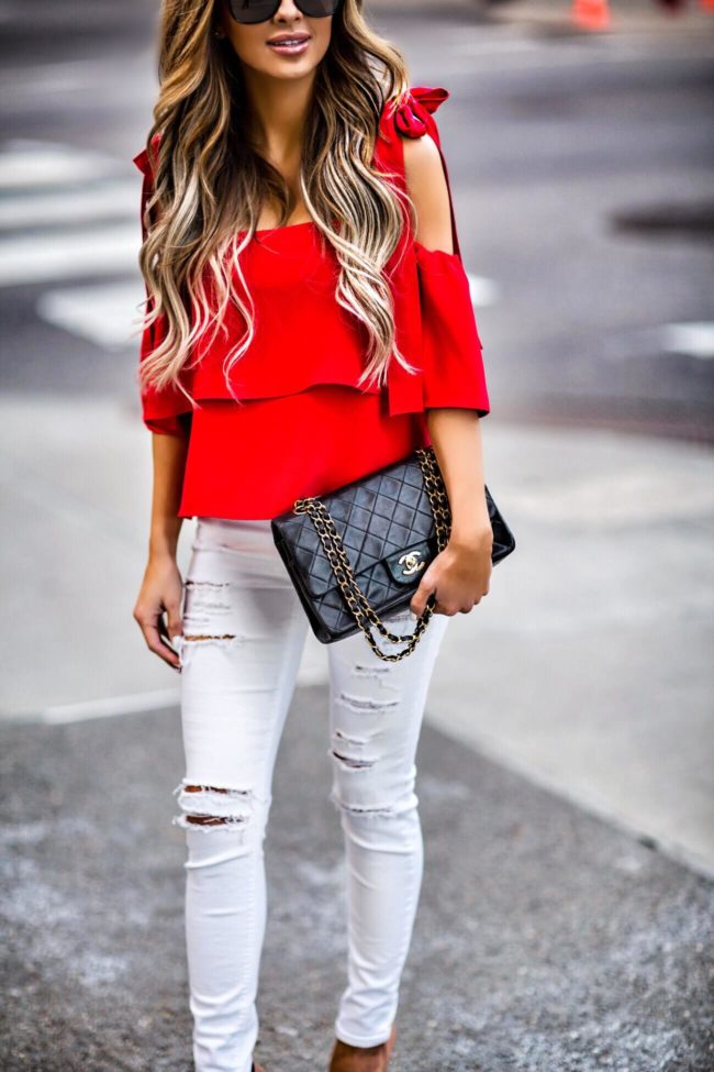 fashion blogger mia mia mine wearing a red bow shoulder top from shopbop and white distressed denim from topshop