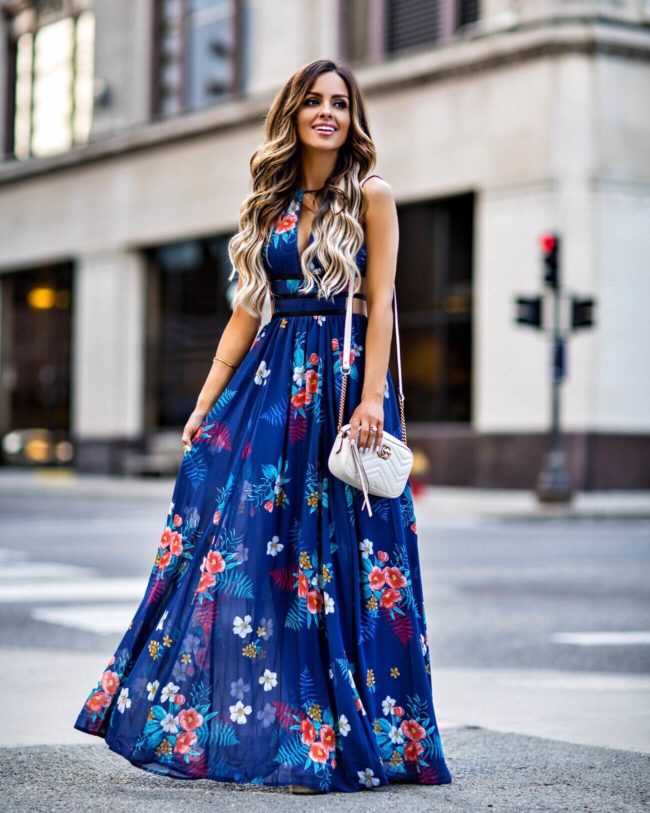 fashion blogger mia mia mine wearing a blue floral maxi dress from express
