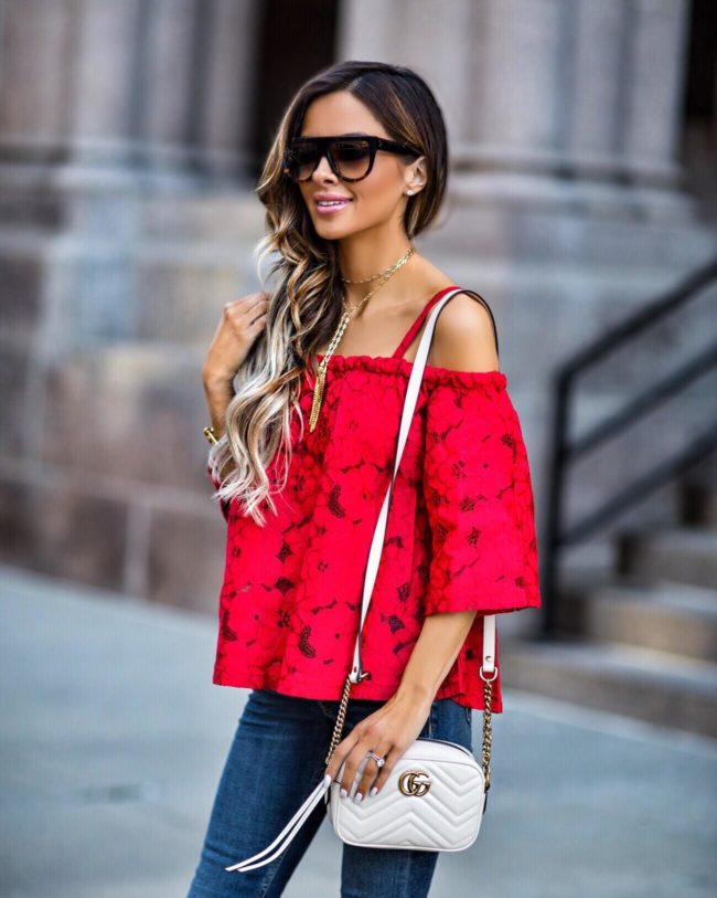 fashion blogger mia mia mine wearing a red lace top by bb dakota and a gucci bag