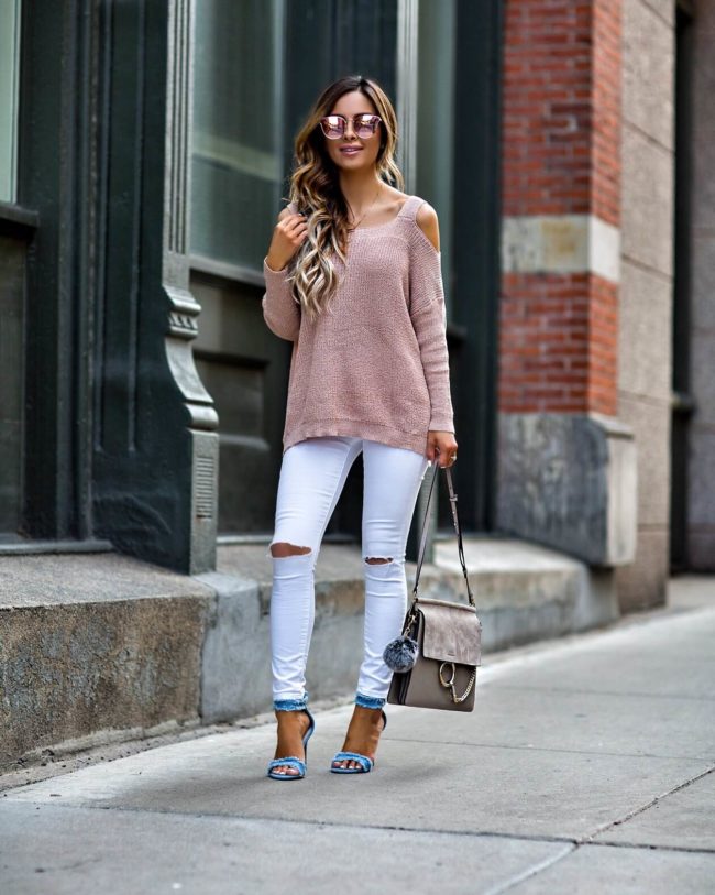 mia mia mine wearing a pink cold shoulder sweater and white jeans from vici collection
