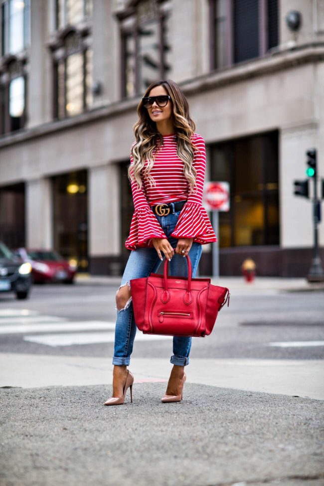 fashion blogger mia mia mine wearing a red striped bell sleeve top from shopbop and a gucci belt
