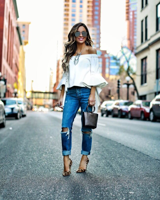 fashion blogger mia mia mine wearing a white off-the-shoulder top from chicwish and grlfrnd denim from revolve