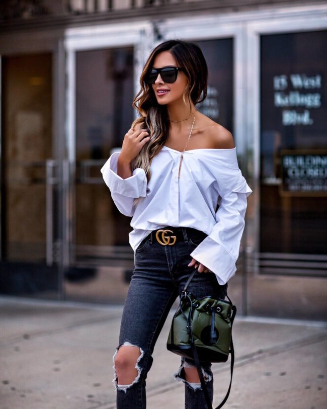 fashion blogger mia mia mine wearing a white off-the-shoulder button-down shirt