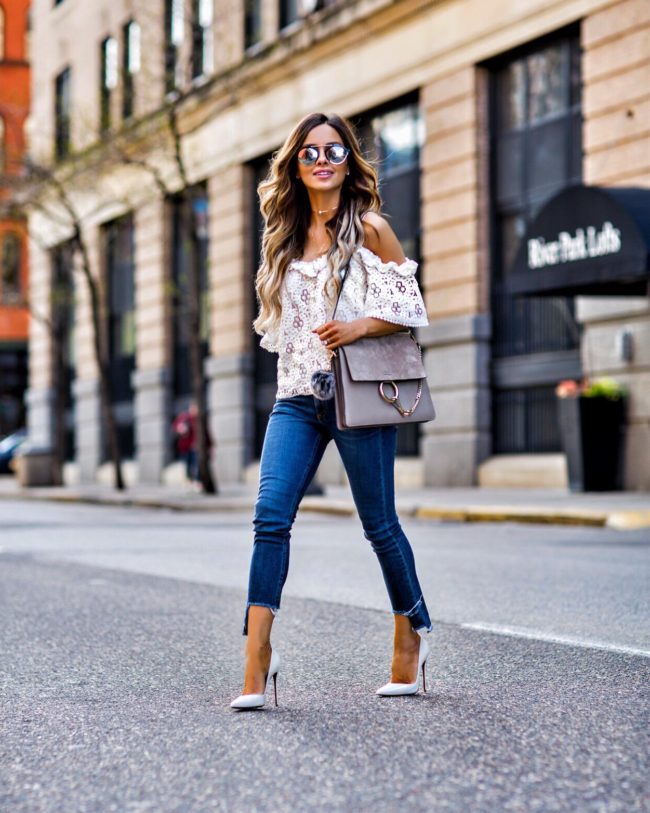 fashion blogger mia mia mine wearing a lace cold shoulder top and white heels