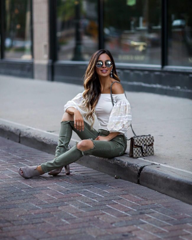 fashion blogger mia mia mine wearing an off-the-shoulder free people top