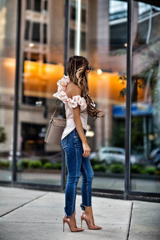 fashion blogger mia mia mine wearing a petersyn striped yellow top from revolve and rag & bone step hem jeans