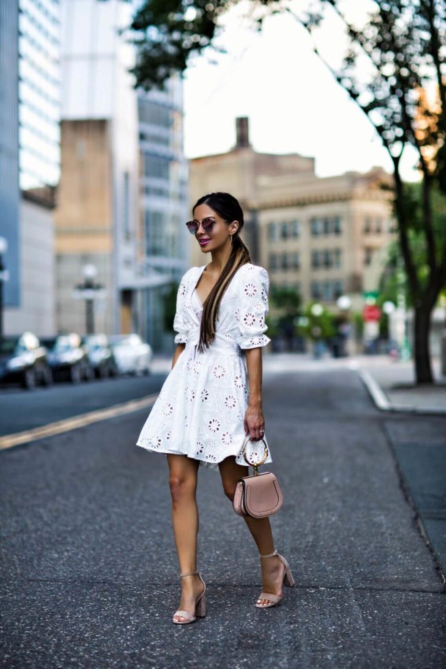 fashion blogger mia mia mine wearing a white lace dress from revolve and a chloe nile bag
