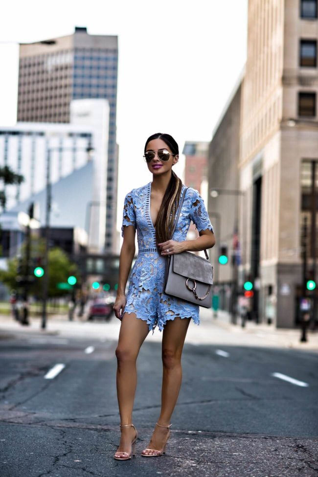 fashion blogger mia mia mine wearing a blue lace romper from nordstrom and nude heels