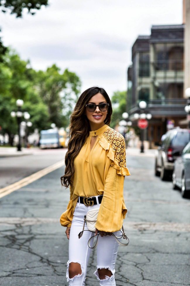 fashion blogger mia mia mine wearing a yellow free people cut-out top from macy's