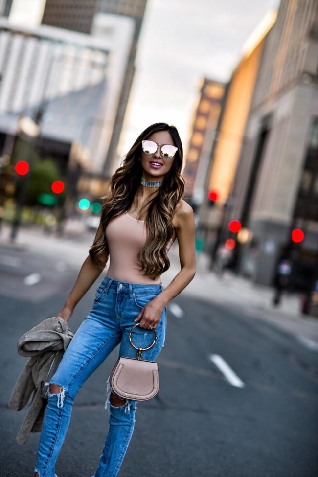fashion blogger mia mia mine wearing a pink bodysuit and a choker from revolve