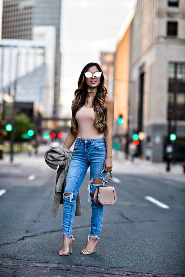 fashion blogger mia mia mine wearing a blush bodysuit and quay pink sunglasses from revolve