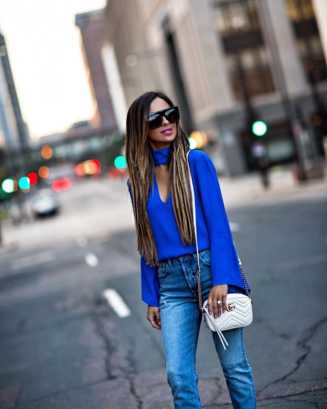 fashion blogger mia mia mine wearing an electric blue top from revolve