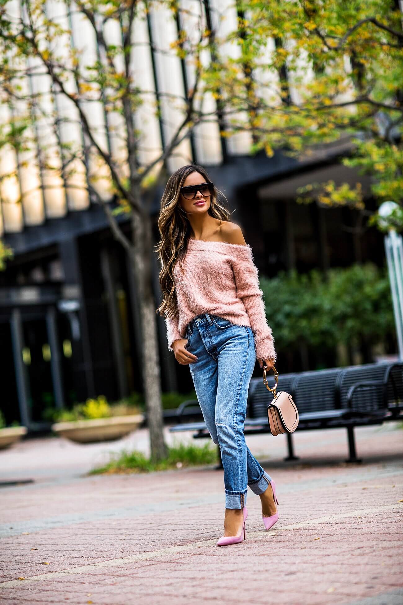 fashion blogger mia mia mine wearing a pink off-the-shoulder sweater 