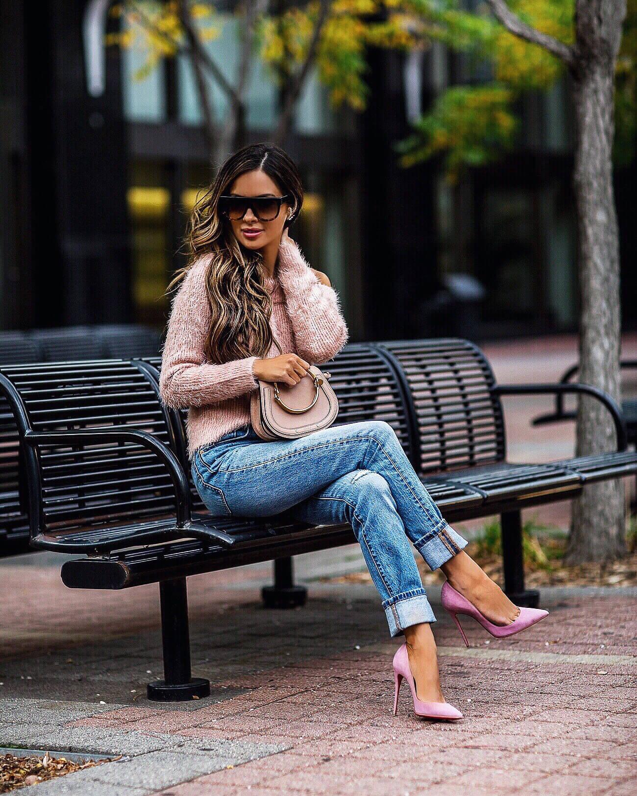 fashion blogger mia mia mine wearing a pink sweater from revolve