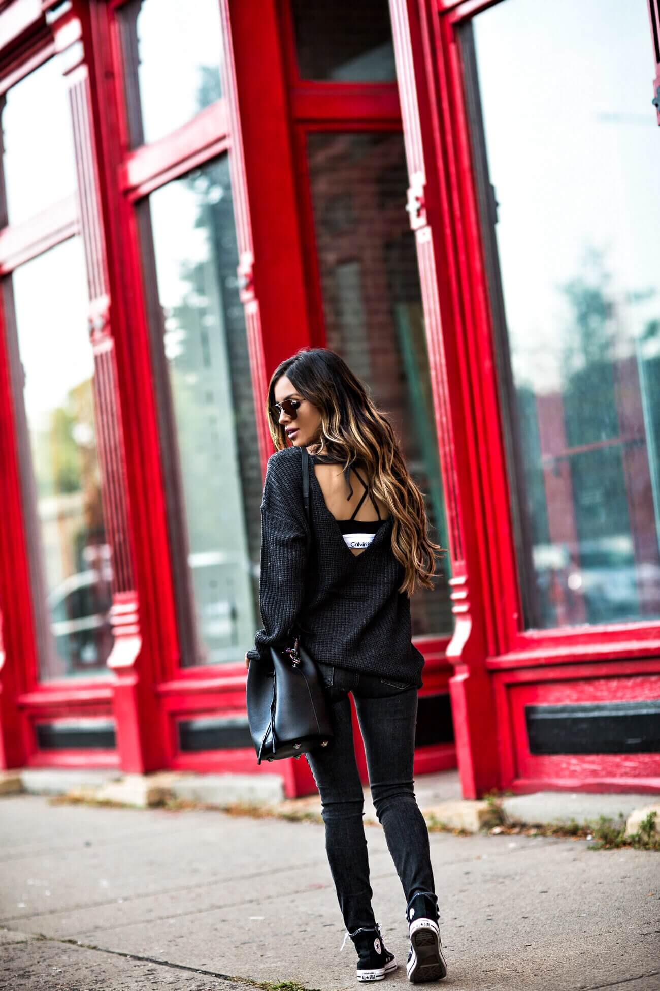 fashion blogger mia mia mine wearing a backless sweater and a calvin klein bra from bloomindale's