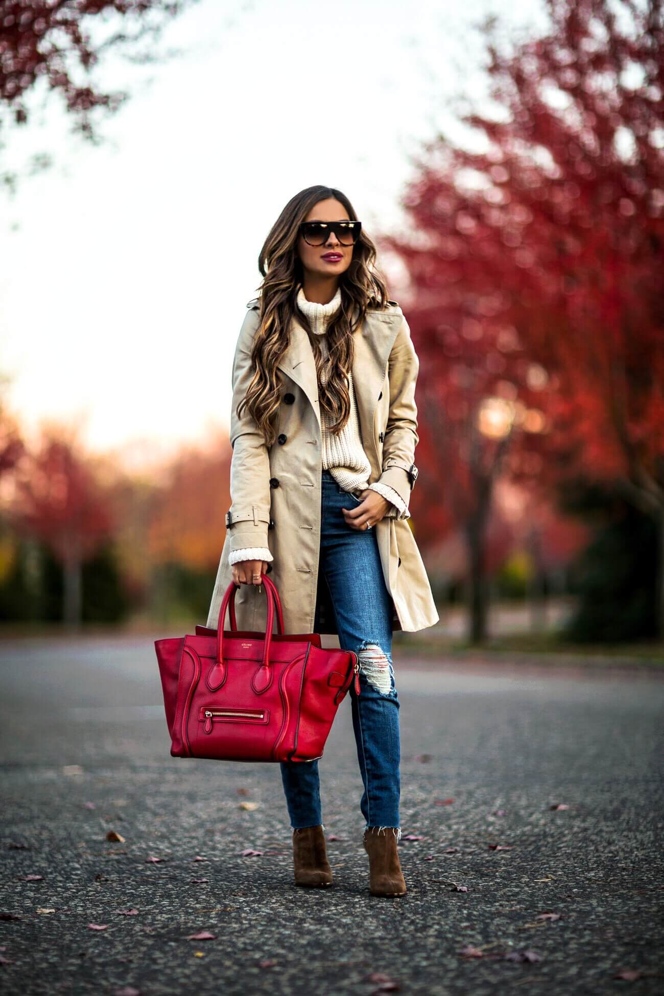 fashion blogger mia mia mine wearing a burberry jacket and a celine red bag