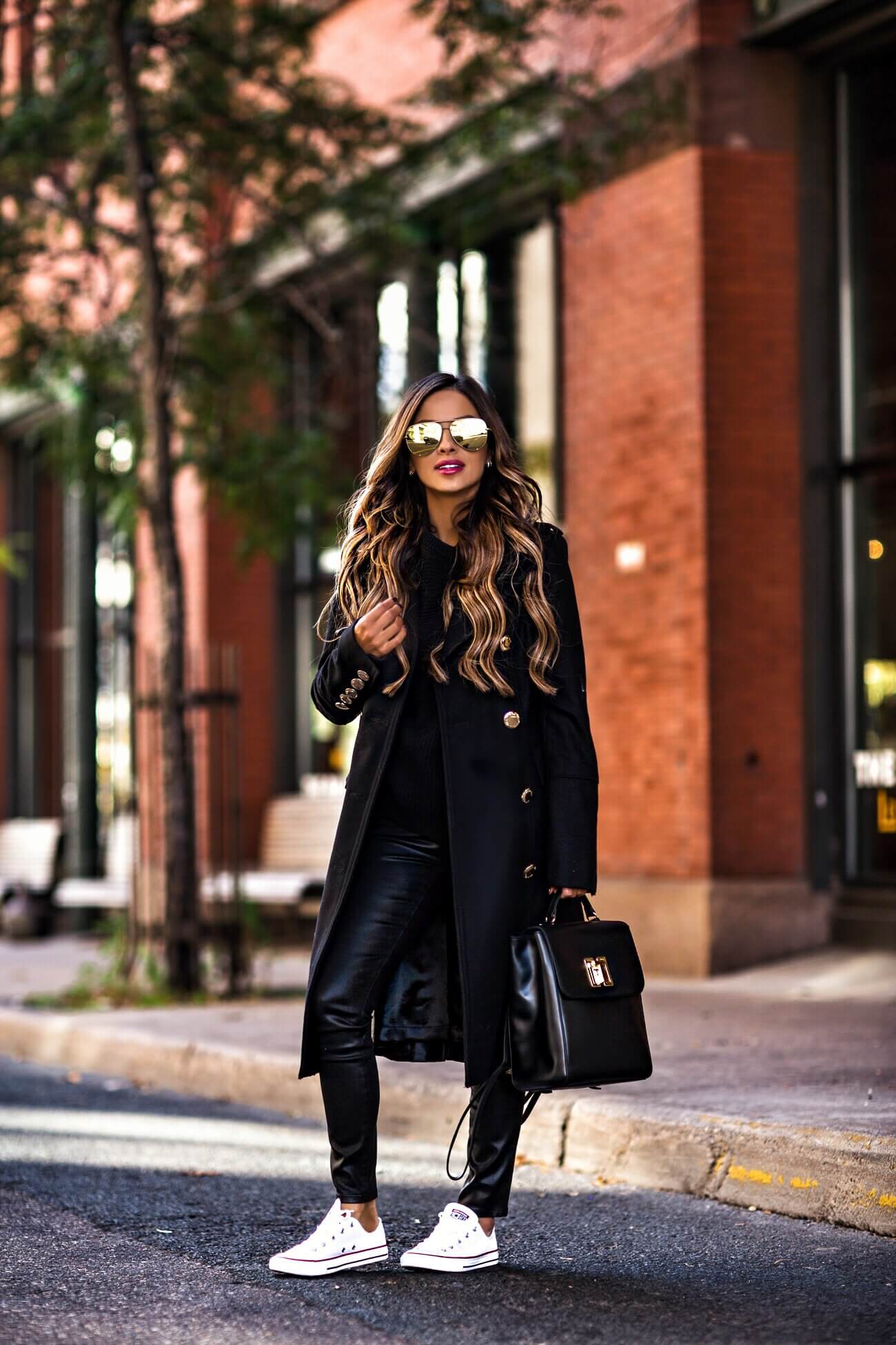 fashion blogger wearing a double breasted black coat by calvin klein