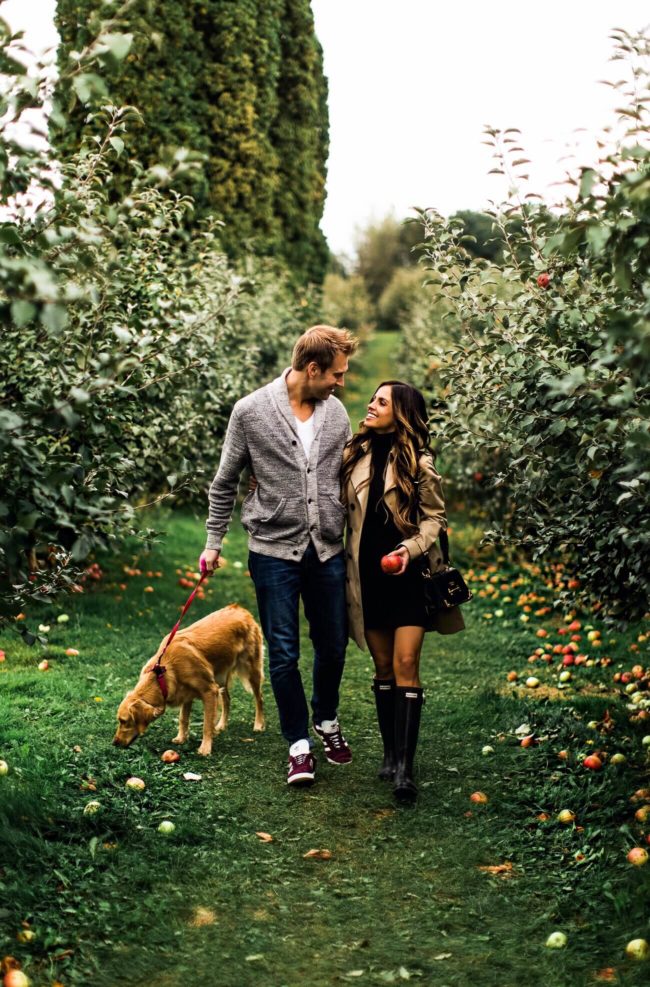 fashion blogger mia mia mine at an apple orchard with husband phil and golden retriever