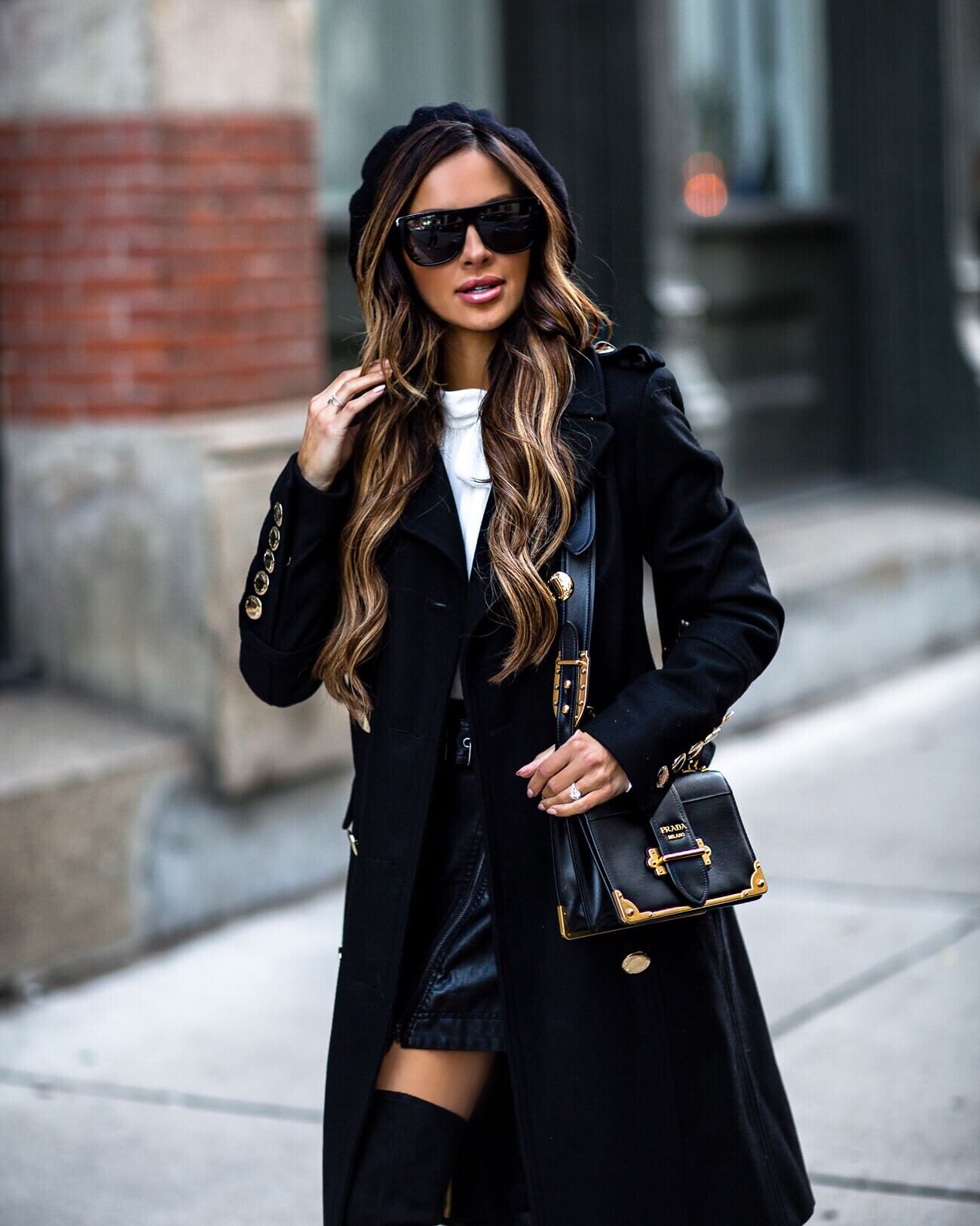 fashion blogger mia mia mine wearing a black coat with gold hardware and beret 