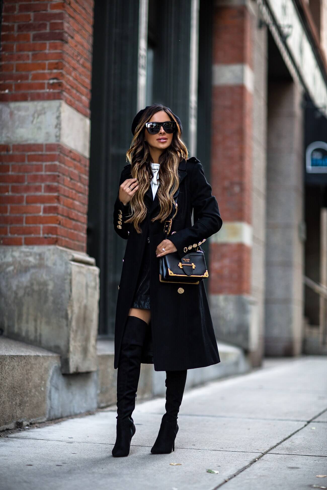 fashion blogger mia mia mine wearing a black coat from macy's and a prada bag