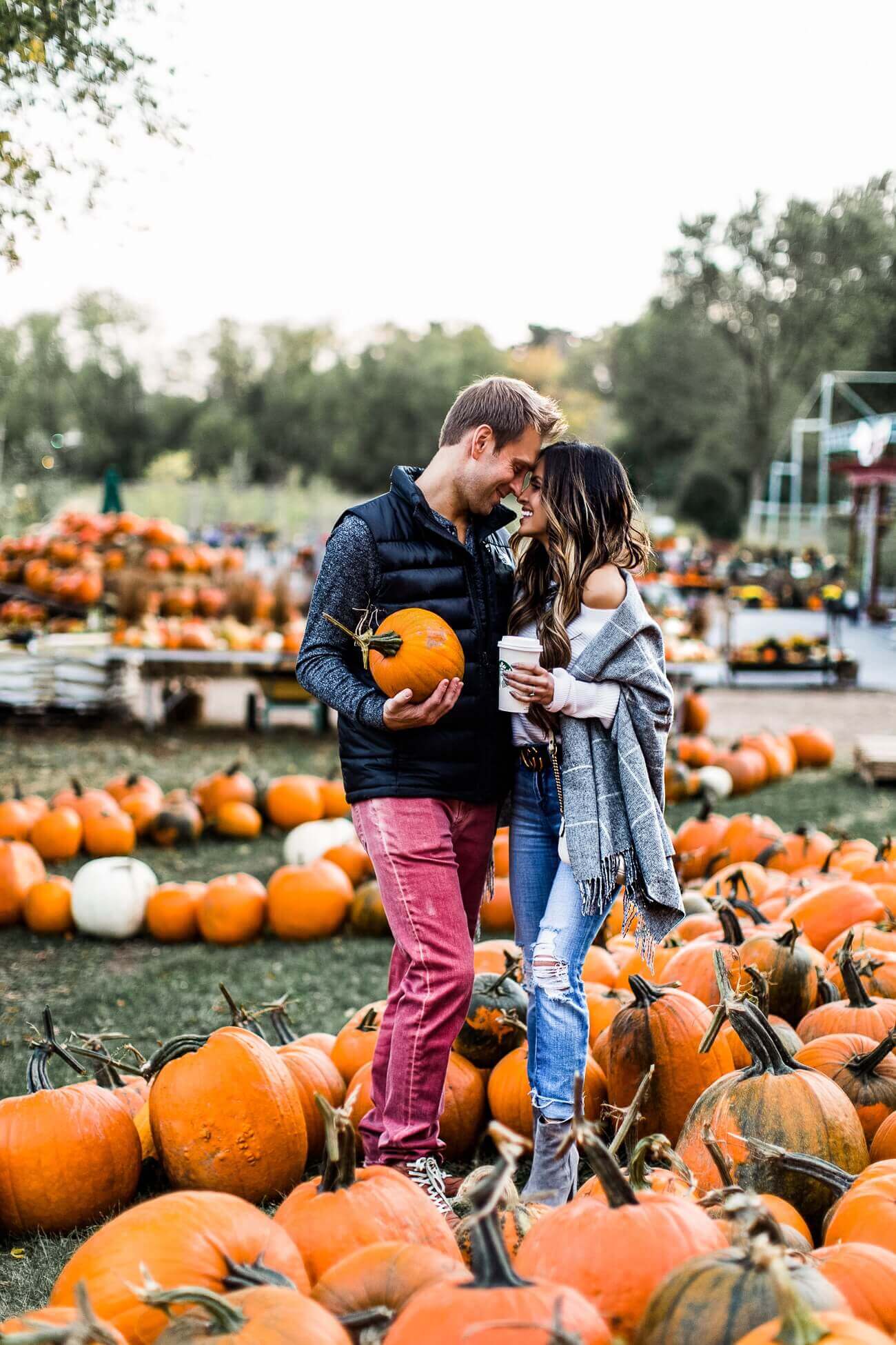 mia mia mine with husband phil at a pumpkin patch fall