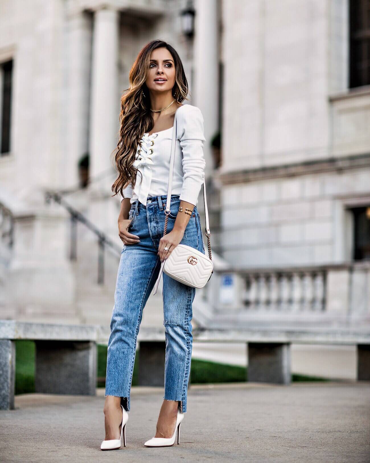 fashion blogger mia mia mine wearing a white lace-up top from free people