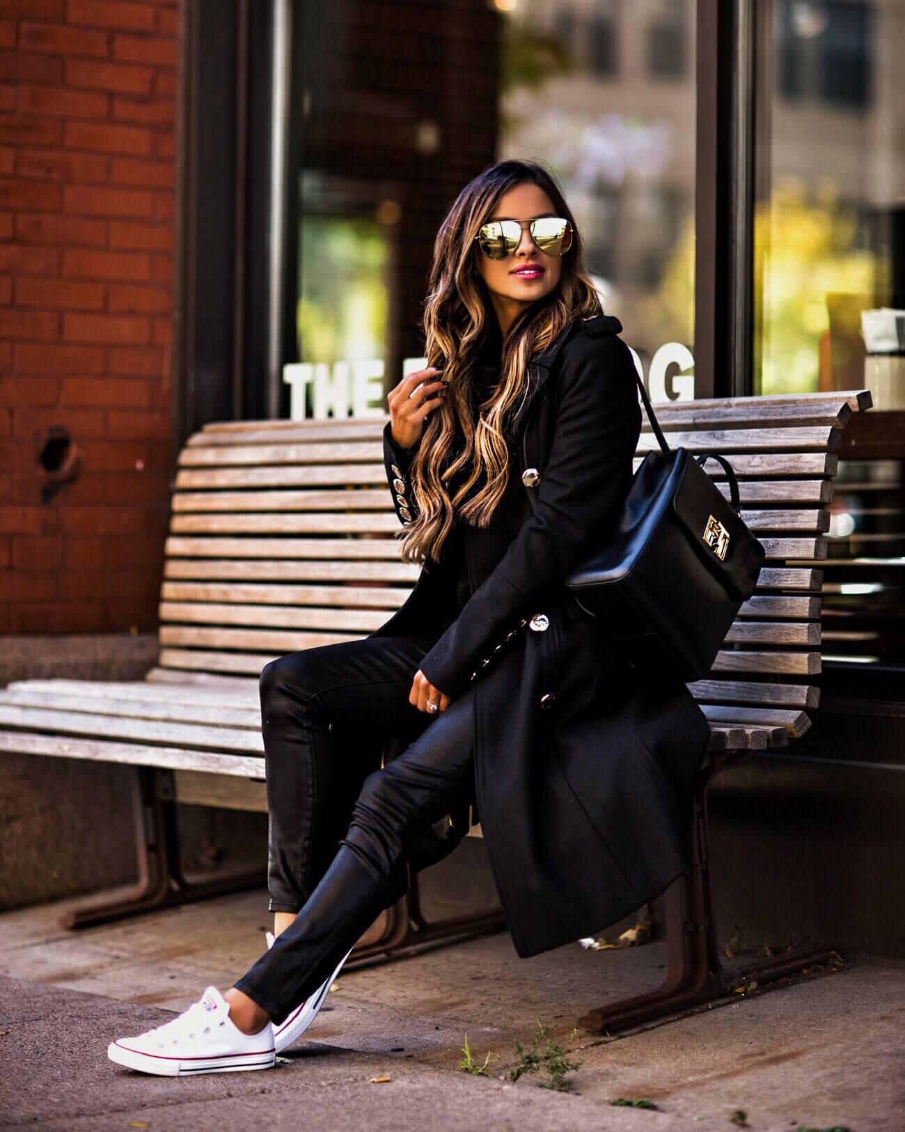 mia mia mine wearing a black coat and converse shoes