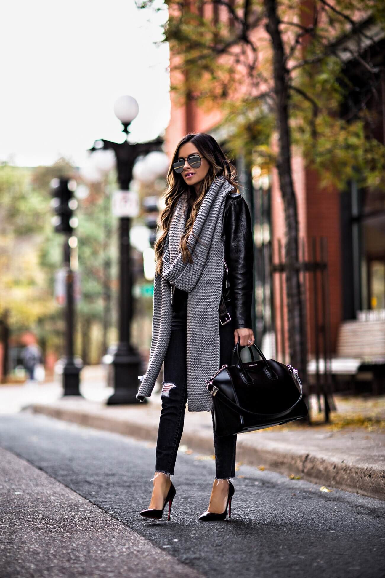 fashion blogger mia mia mine wearing a leather jacket and a givenchy antigona bag
