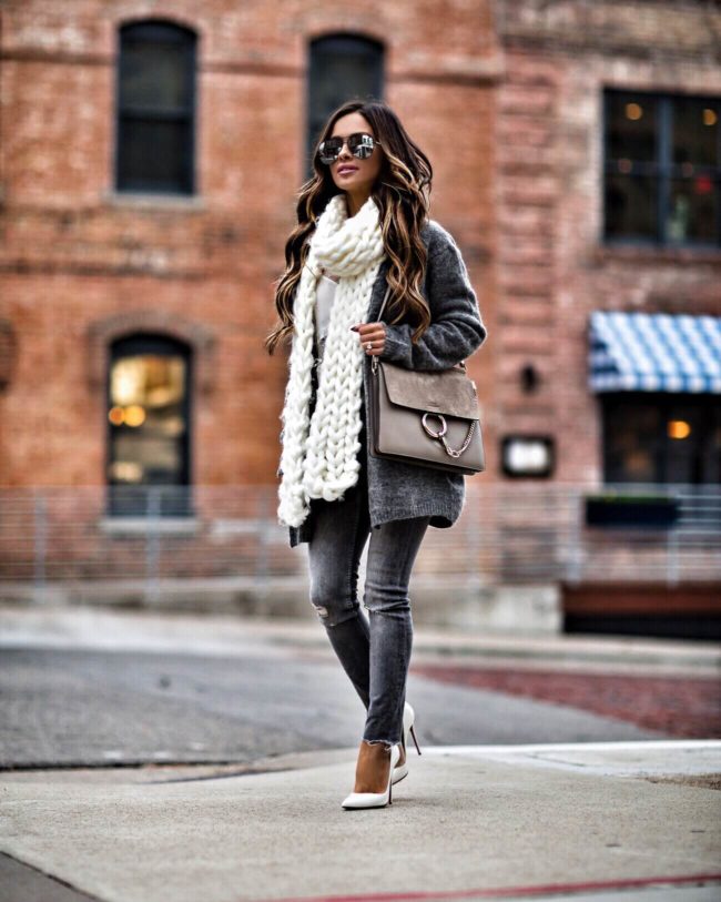 mia mia mine wearing a chunky white scarf and a gray H&M cardigan