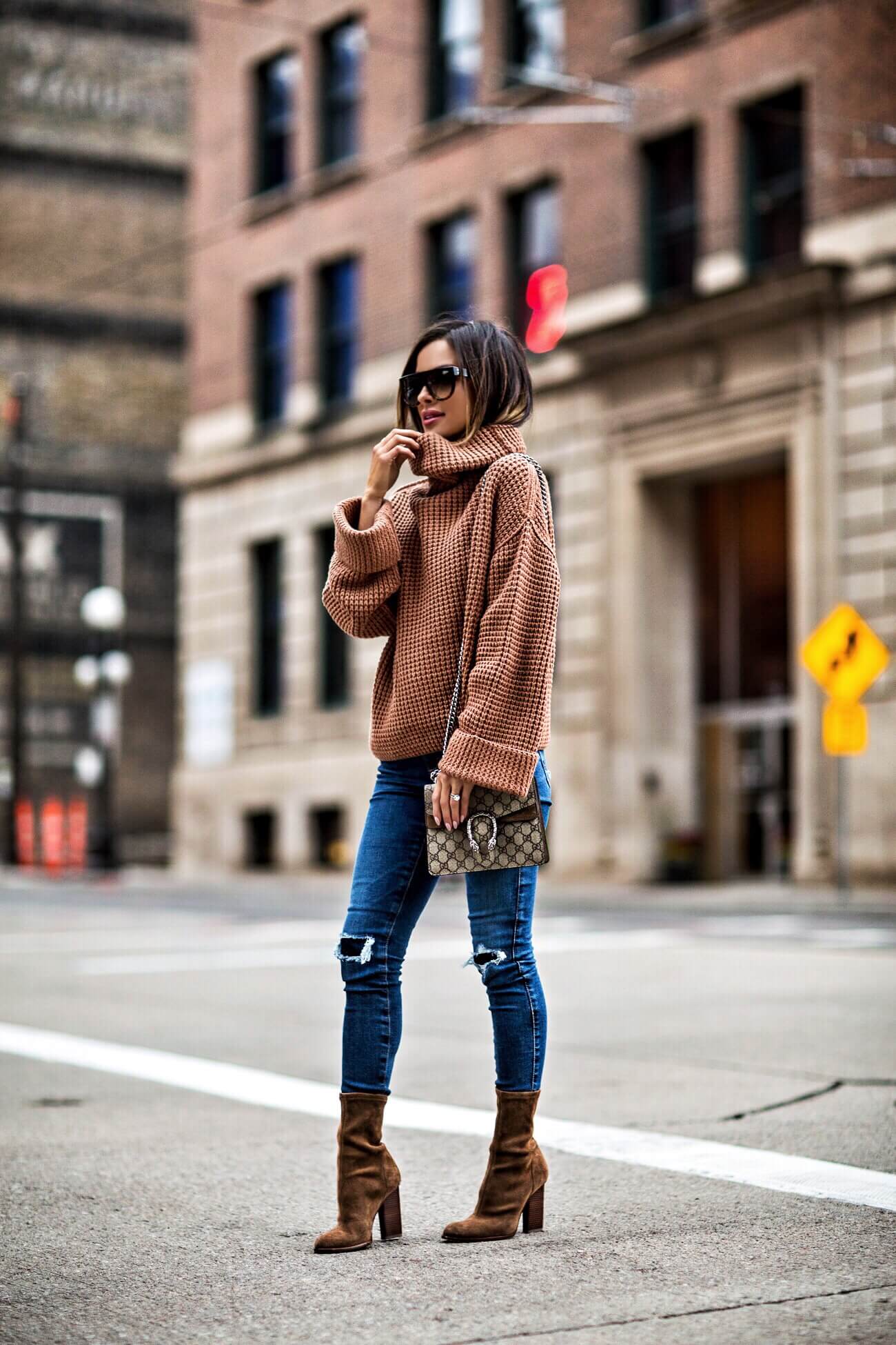 fashion blogger mia mia mine wearing an orange sweater by free people and a gucci dionysus bag