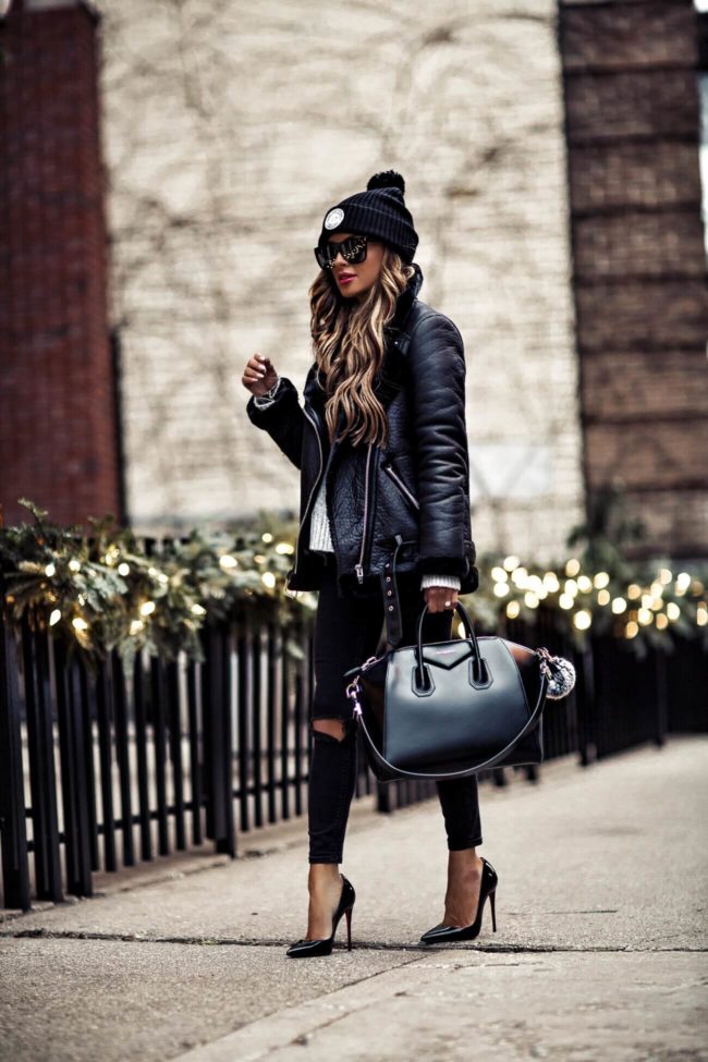 Fashion blogger mia mia mine wearing a givenchy bag and black biker jacket from H&M